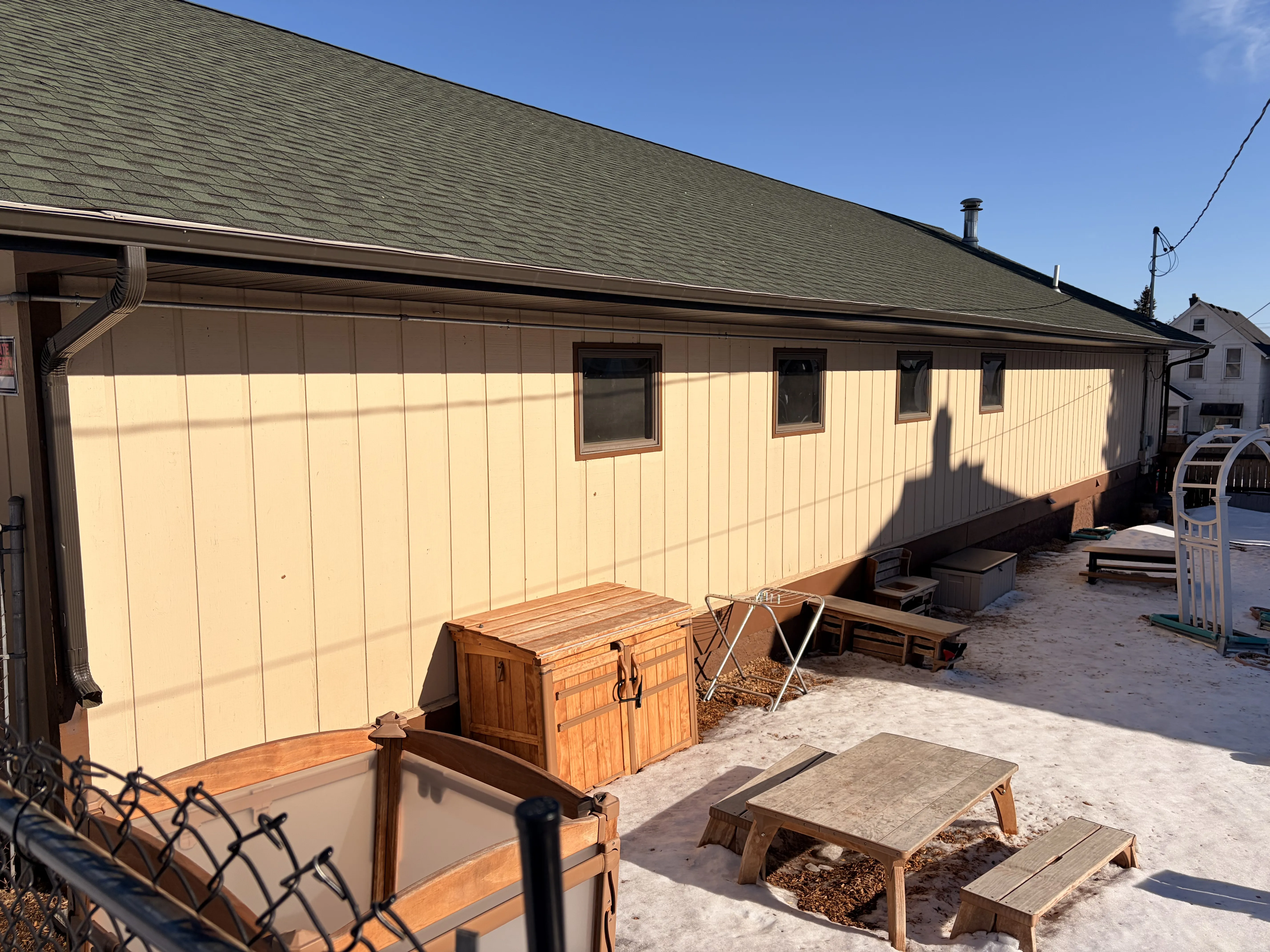 Completed vertical siding installation on the side of a commercial building
