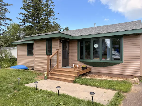 completed exterior siding project surrounded by trees in Duluth area